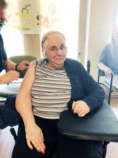 Liz Frazer, resident at Pine Meadow Nursing Home, receives her first COVID-19 vaccination.